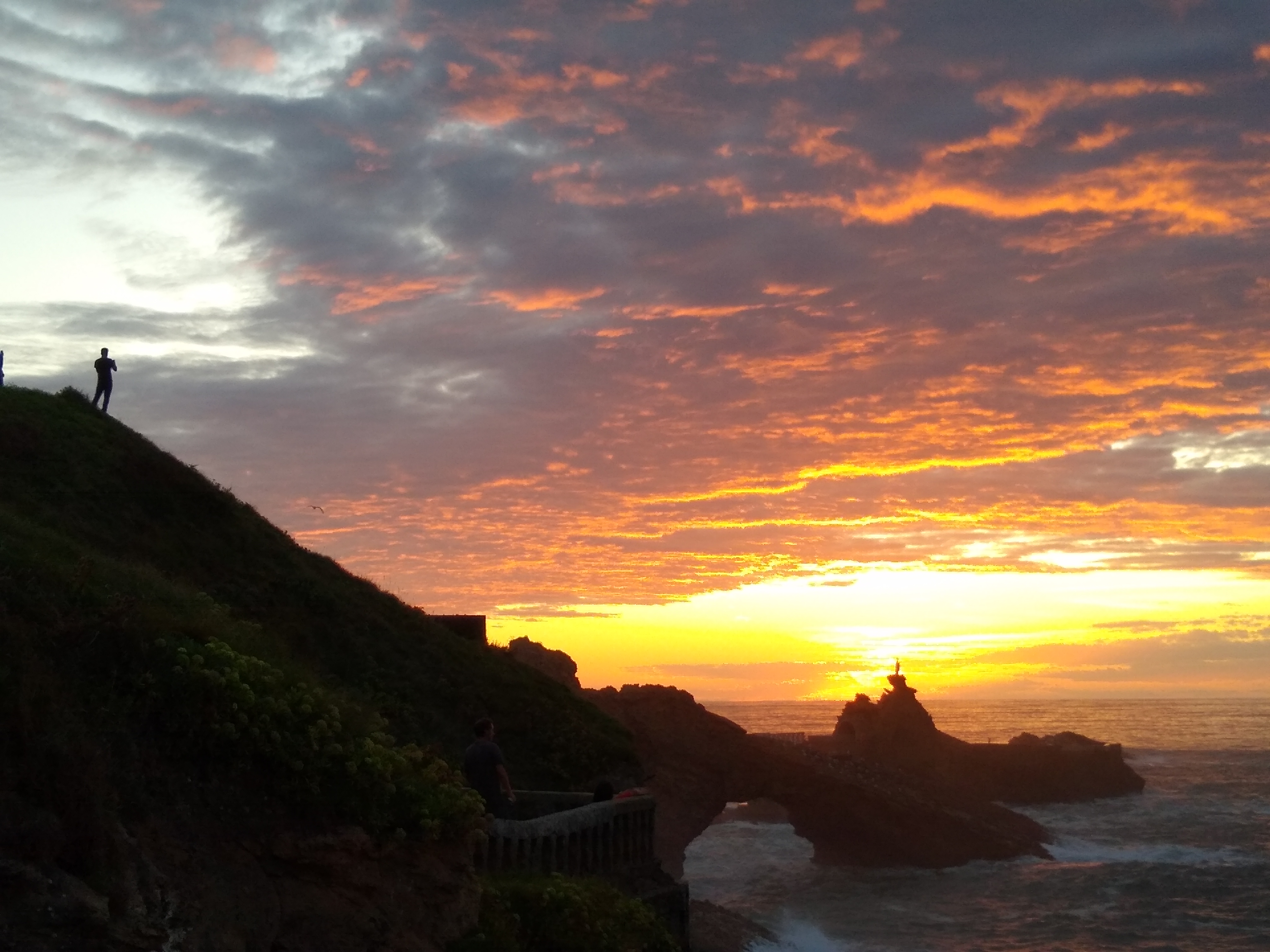 Sunset with man and sea arch